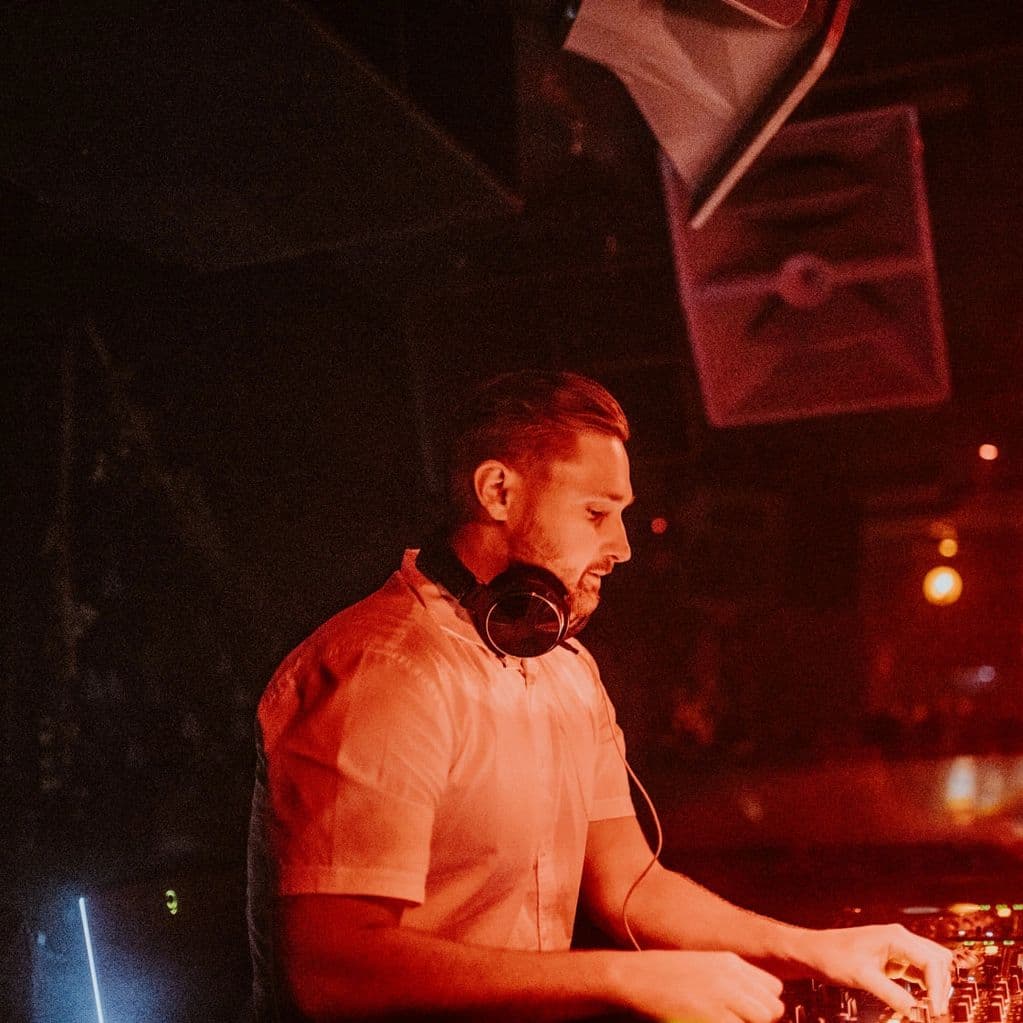 Conrad DJing with headphones at Audio Nightclub